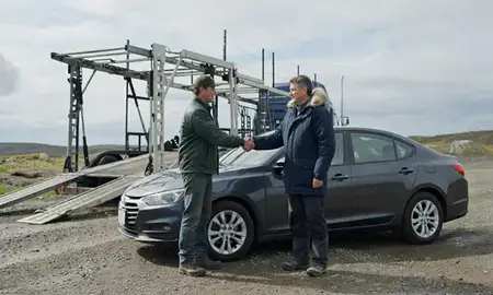 Vehicle owner beside their delivered car in Kodiak, Alaska, United States