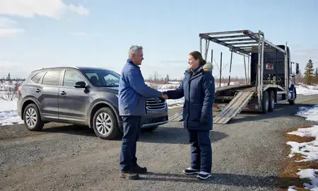 Vehicle owner beside their delivered car in Meadow Lakes, Alaska, United States