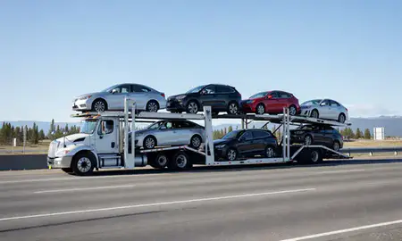 Multi-level car carrier on the highway to Nikiski, Alaska, United States