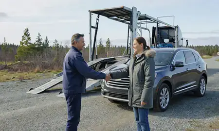 Vehicle owner beside their delivered car in North Lakes, Alaska, United States