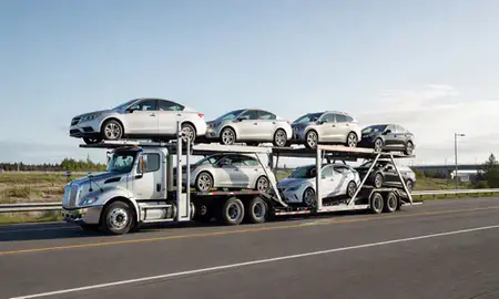 Multi-level car carrier on the highway to Palmer, Alaska, United States
