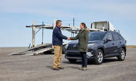 Vehicle owner beside their delivered car in Palmer, Alaska, United States