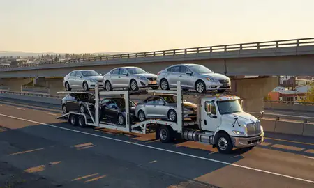 Car transporter with the Palmer, Alaska, United States skyline behind it