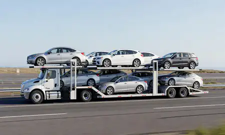 Multi-level car carrier on the highway to Sitka, Alaska, United States