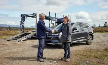 Vehicle owner beside their delivered car in South Lakes, Alaska, United States