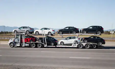 Multi-level car carrier on the highway to Steele Creek, Alaska, United States