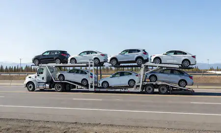 Multi-level car carrier on the highway to Sterling, Alaska, United States