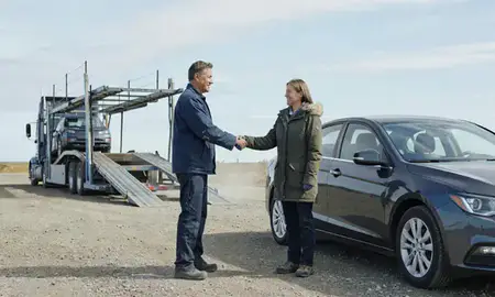Vehicle owner beside their delivered car in Sterling, Alaska, United States