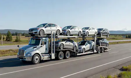 Multi-level car carrier on the highway to Tanaina, Alaska, United States