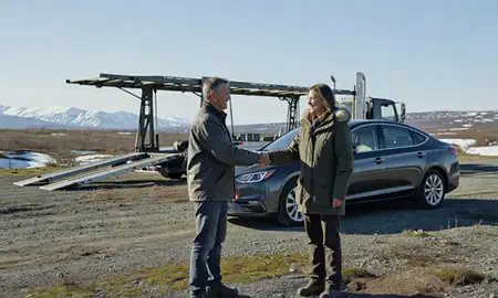 Vehicle owner beside their delivered car in Tanaina, Alaska, United States