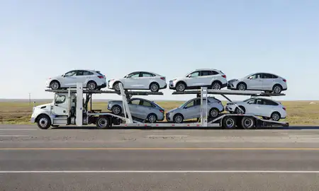Multi-level car carrier on the highway to Utqiagvik, Alaska, United States