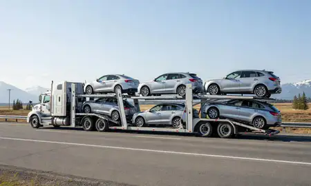 Multi-level car carrier on the highway to Valdez, Alaska, United States