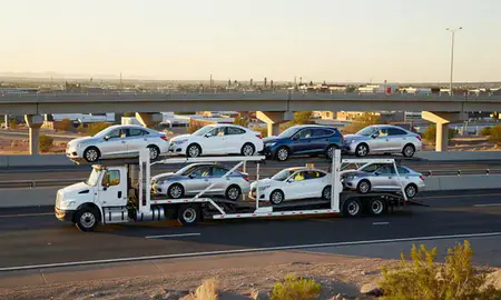 Car transporter with the Avondale, Arizona, United States skyline behind it