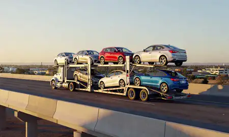 Car transporter with the Casa Grande, Arizona, United States skyline behind it