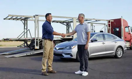 Vehicle owner beside their delivered car in Peoria, Arizona, United States