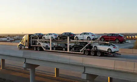 Car transporter with the Bryant, Arkansas, United States skyline behind it