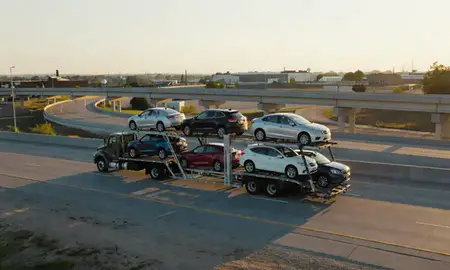 Car transporter with the West Memphis, Arkansas, United States skyline behind it