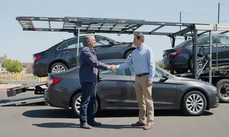 Vehicle owner beside their delivered car in Fontana, California, United States