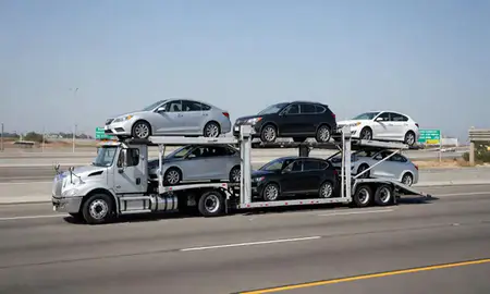 Multi-level car carrier on the highway to Irvine, California, United States