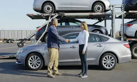 Vehicle owner beside their delivered car in Oakland, California, United States