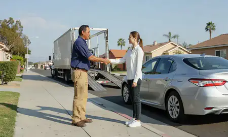 Vehicle owner beside their delivered car in Santa Ana, California, United States