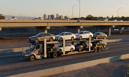 Car transporter with the Santa Ana, California, United States skyline behind it