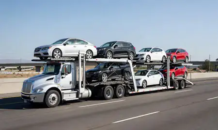 Multi-level car carrier on the highway to Stockton, California, United States