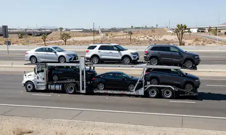 Multi-level car carrier on the highway to Victorville, California, United States