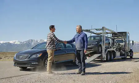Vehicle owner beside their delivered car in Colorado, United States