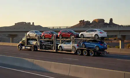 Car transporter with the Castle Rock, Colorado, United States skyline behind it