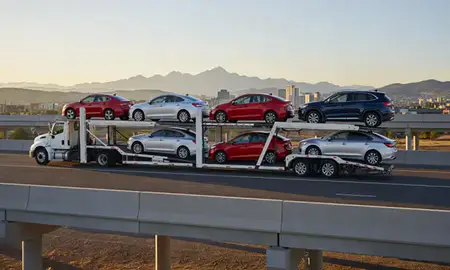 Car transporter with the Colorado Springs, Colorado, United States skyline behind it