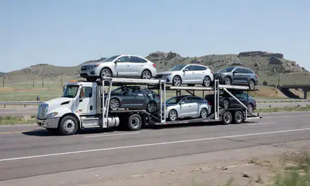 Multi-level car carrier on the highway to Dakota Ridge, Colorado, United States