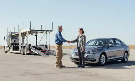 Vehicle owner beside their delivered car in Denver, Colorado, United States