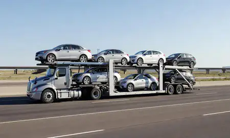 Multi-level car carrier on the highway to Englewood, Colorado, United States