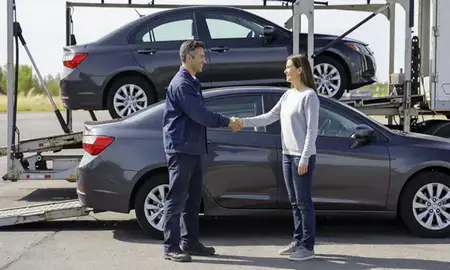 Vehicle owner beside their delivered car in Englewood, Colorado, United States
