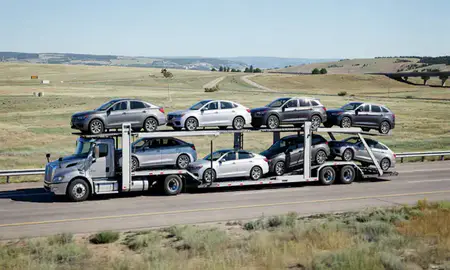 Multi-level car carrier on the highway to Ken Caryl, Colorado, United States