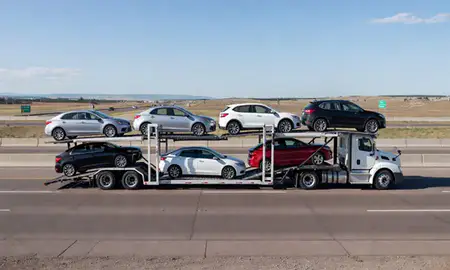 Multi-level car carrier on the highway to Lakewood, Colorado, United States
