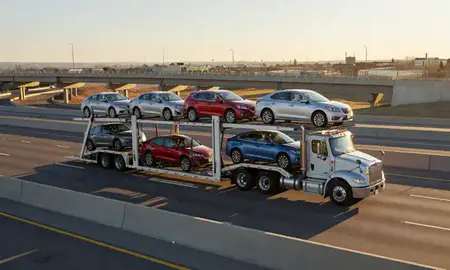 Car transporter with the Windsor, Colorado, United States skyline behind it