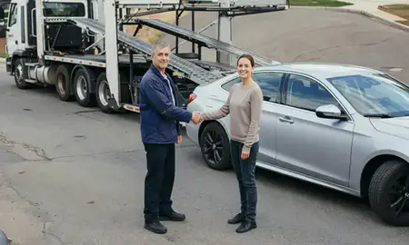 Vehicle owner beside their delivered car in Bristol, Connecticut, United States
