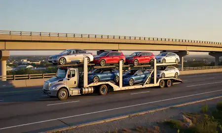 Car transporter with the Conning Towers Nautilus Park, Connecticut, United States skyline behind it