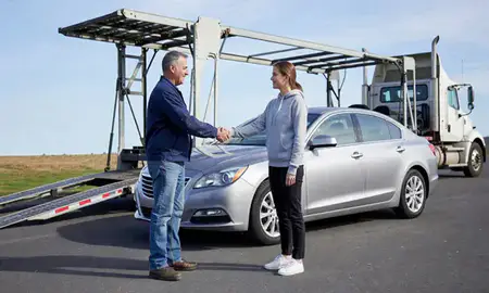 Vehicle owner beside their delivered car in Storrs, Connecticut, United States