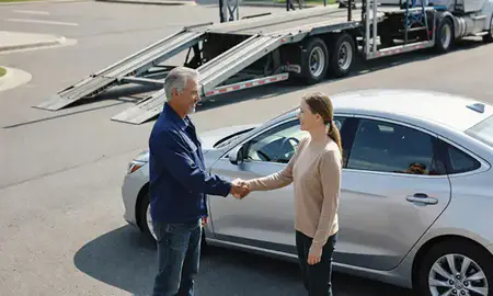 Vehicle owner beside their delivered car in Wallingford Center, Connecticut, United States