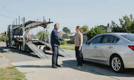 Vehicle owner beside their delivered car in West Haven, Connecticut, United States