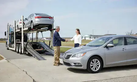 Vehicle owner beside their delivered car in Dover, Delaware, United States