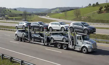 Multi-level car carrier on the highway to Pike Creek Valley, Delaware, United States
