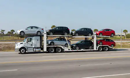 Multi-level car carrier on the highway to Leesburg, Florida, United States
