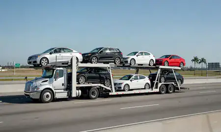 Multi-level car carrier on the highway to Miami, Florida, United States
