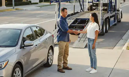 Vehicle owner beside their delivered car in Panama City, Florida, United States