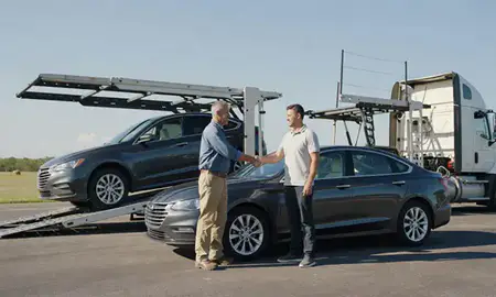 Vehicle owner beside their delivered car in Pensacola, Florida, United States