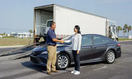 Vehicle owner beside their delivered car in Port St. Lucie, Florida, United States